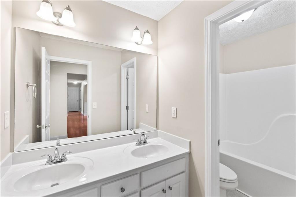 241 Red Bud Road Jefferson, GA 30549 - Photo 8 of 43 a bathroom with a sink a toilet and shower