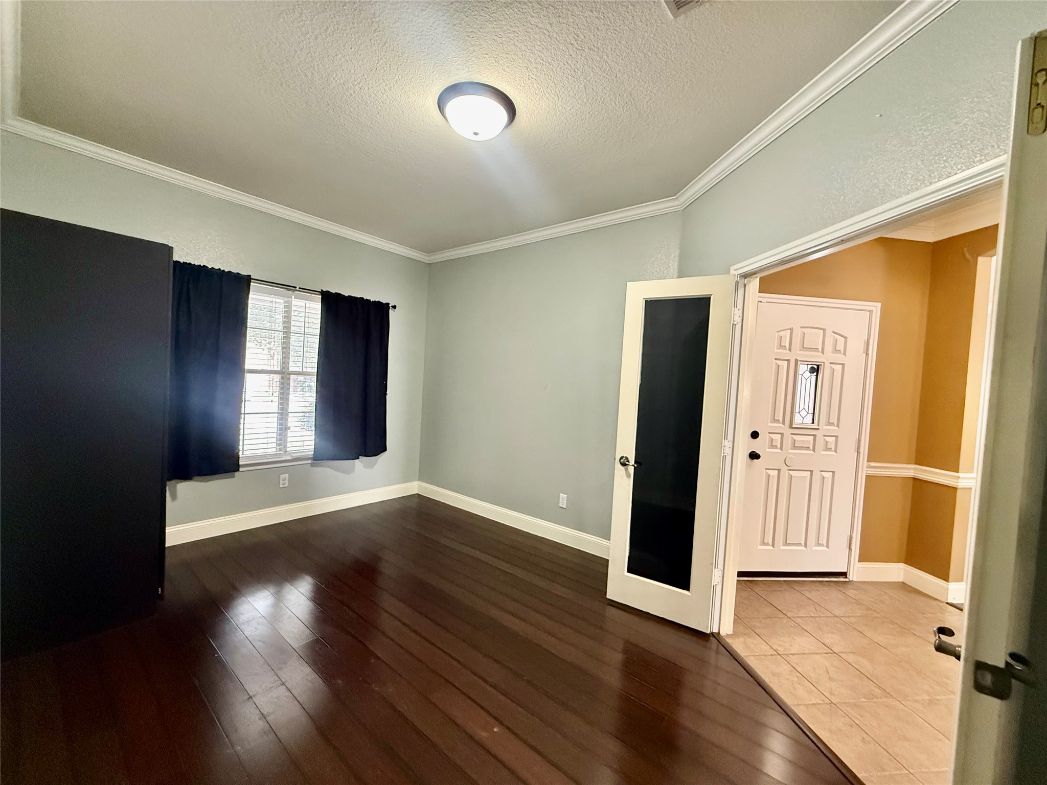 12820 Waynespur Lane Elgin, TX 78621 - Photo 5 of 26 Office featuring a textured ceiling, dark wood-style flooring, and crown molding