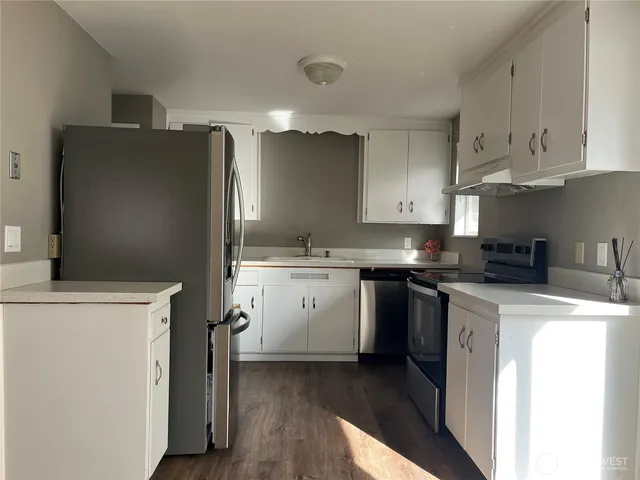 a kitchen with a sink a stove and refrigerator