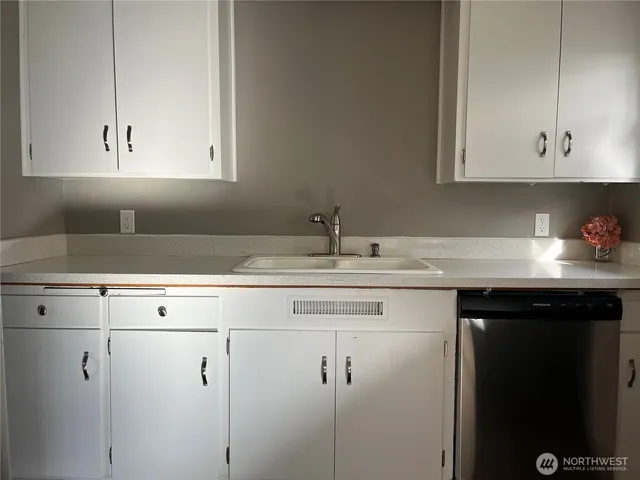 a kitchen with a sink and cabinets