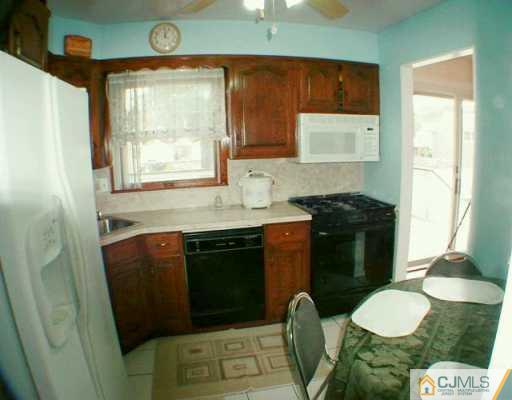 35 Mercer Road Old Bridge, NJ 08857 - Photo 4 of 8 a kitchen with a sink a toilet and cabinets