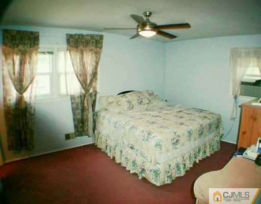 35 Mercer Road Old Bridge, NJ 08857 - Photo 5 of 8 a bed sitting in a bedroom next to a window and a chandelier