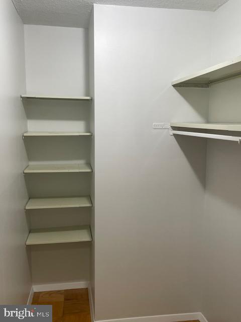 1301 20th Street Northwest, Unit 316 Washington, DC 20036 - Photo 5 of 9 a view of walk in closet with empty racks