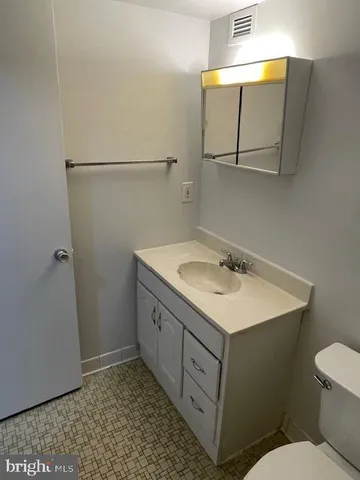 a bathroom with a sink a toilet and mirror