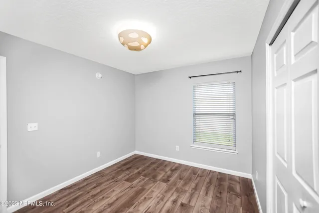 a view of room with window and hardwood floor