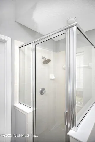 a bathroom with a glass shower door