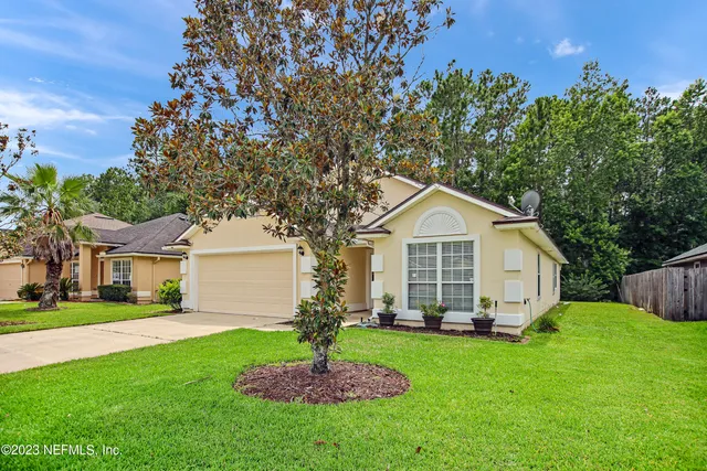 a front view of house with yard and green space