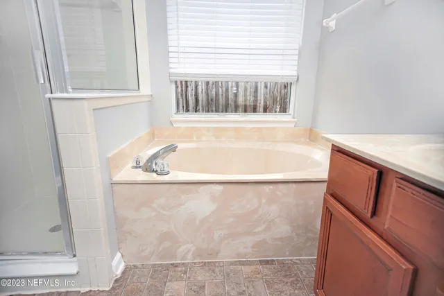a bath tub sitting next to a window