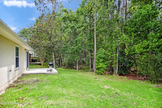 a view of a house with a backyard porch and sitting area