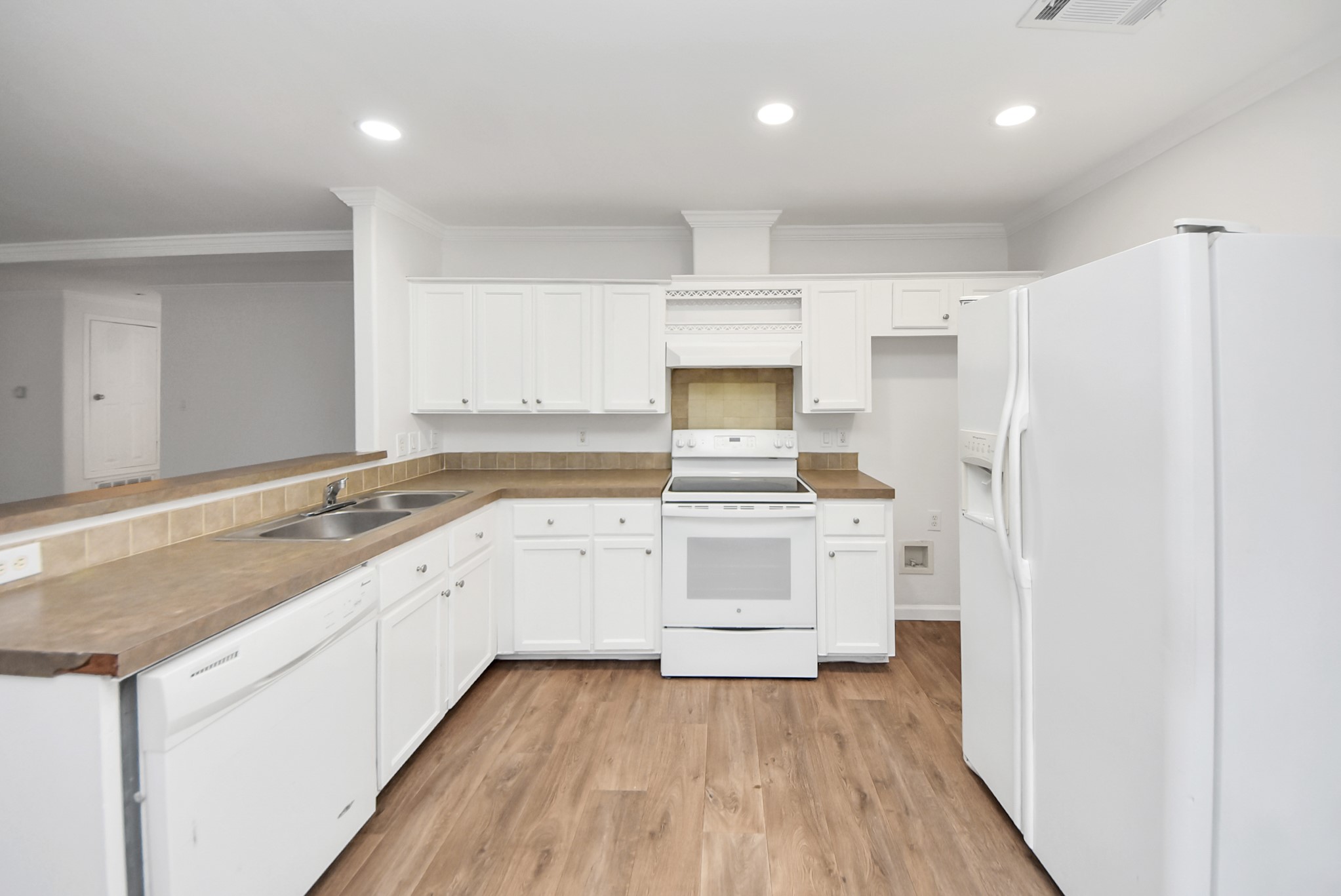 6526 Carver Road, Unit A Houston, TX 77091 - Photo 11 of 31 a kitchen with granite countertop white cabinets and white appliances
