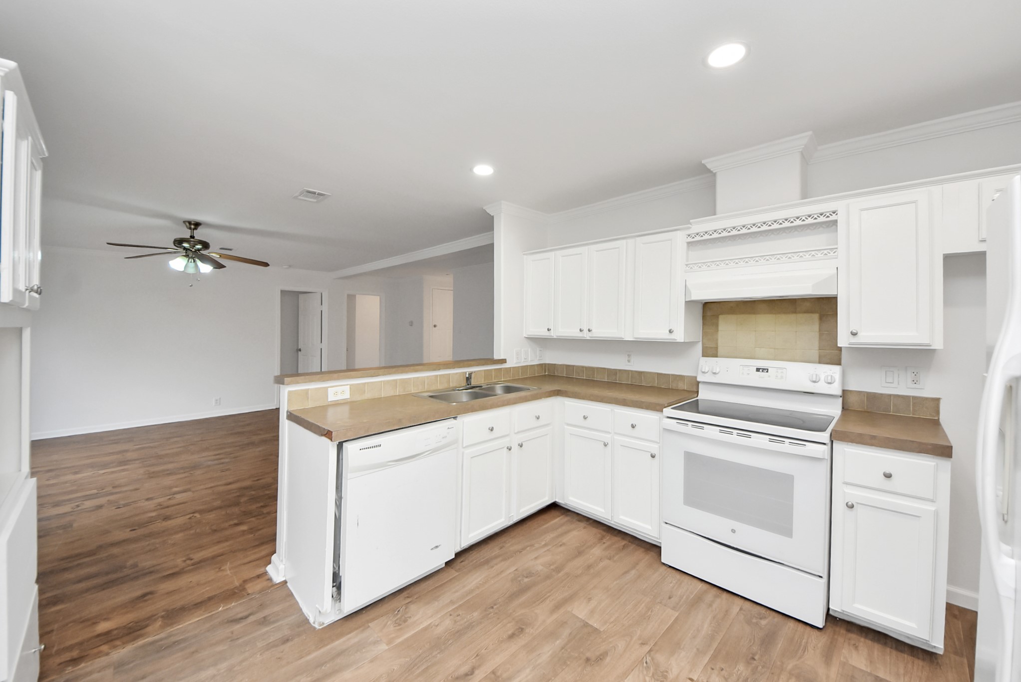 6526 Carver Road, Unit A Houston, TX 77091 - Photo 12 of 31 a kitchen with a stove a sink and wooden floor