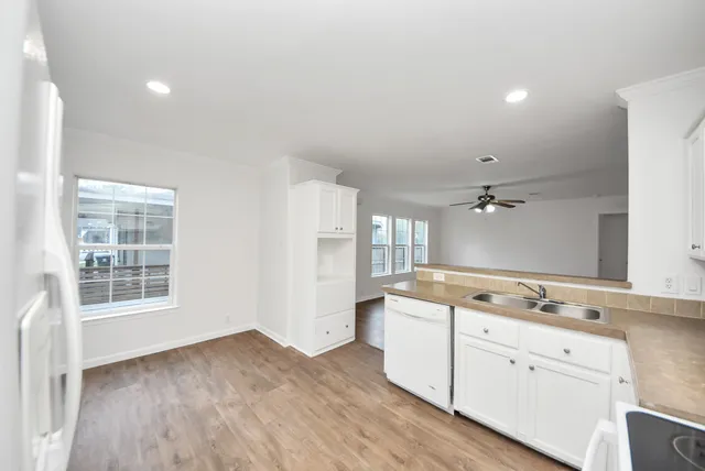 a view of cabinets and wooden floor