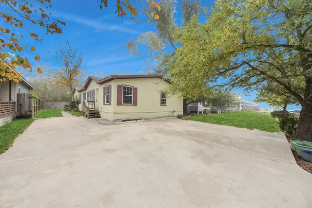 a view of a house with a yard and garage