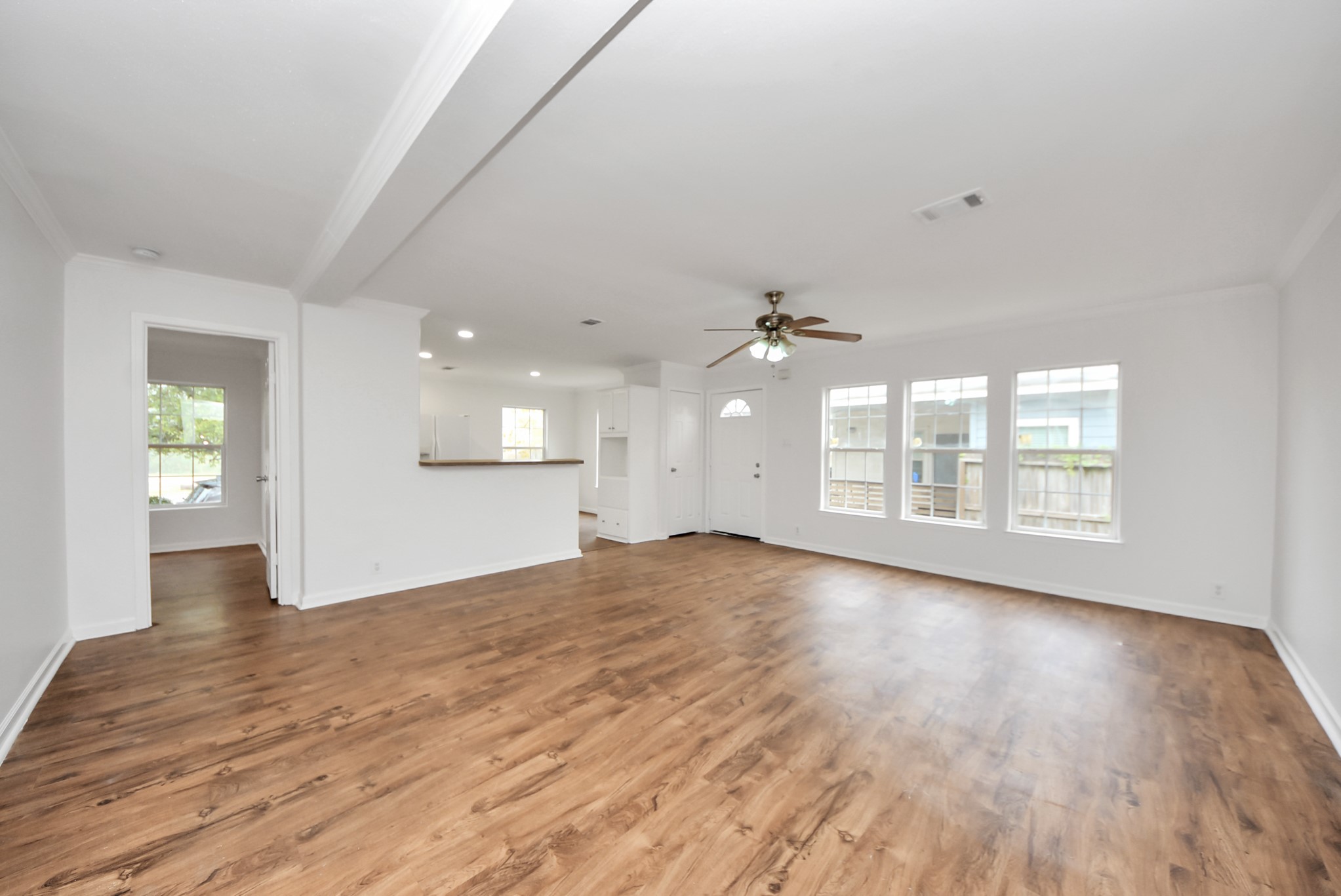 6526 Carver Road, Unit A Houston, TX 77091 - Photo 4 of 31 an empty room with wooden floor and windows
