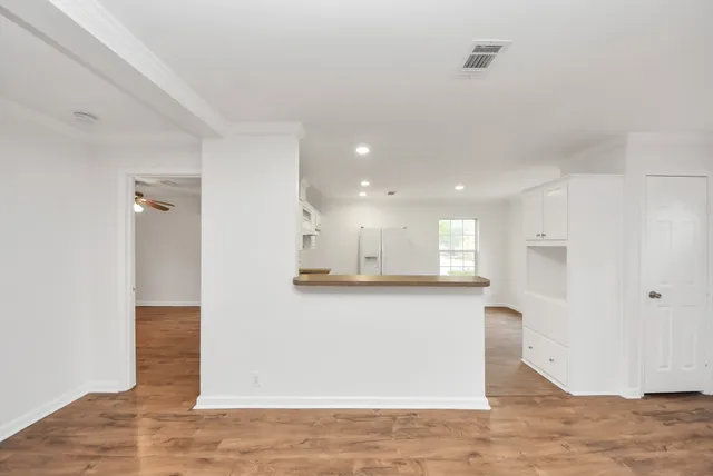 a view of a kitchen with wooden floor