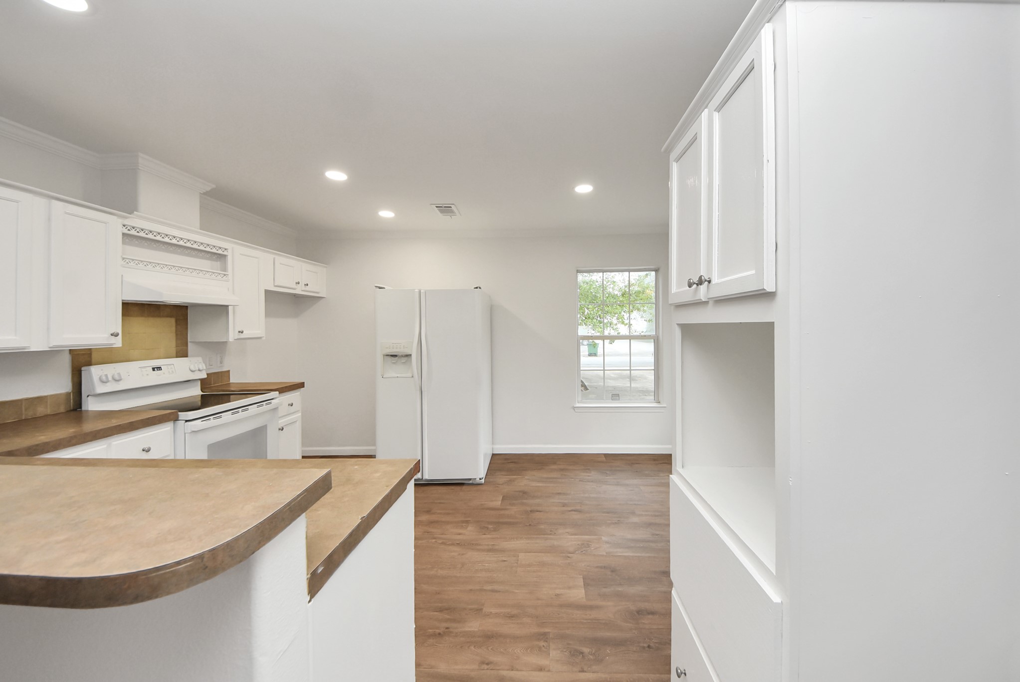 6526 Carver Road, Unit A Houston, TX 77091 - Photo 9 of 31 a kitchen with stainless steel appliances granite countertop a sink a stove and a refrigerator