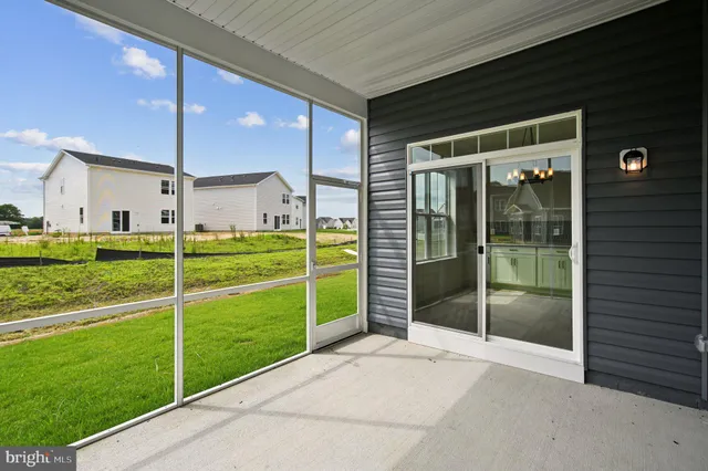 a view of an empty room with floor to ceiling window and stairs