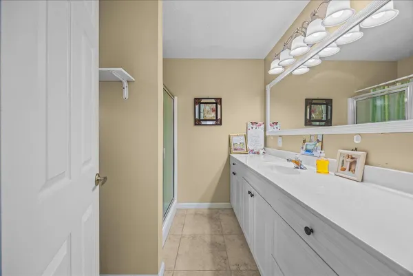 a bathroom with a sink a mirror and a vanity
