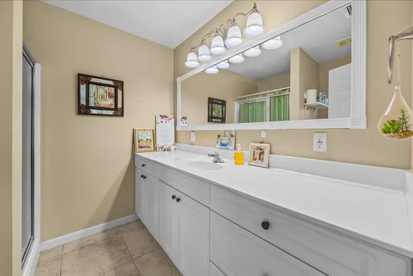 a picture of a bathroom with a large window and shower