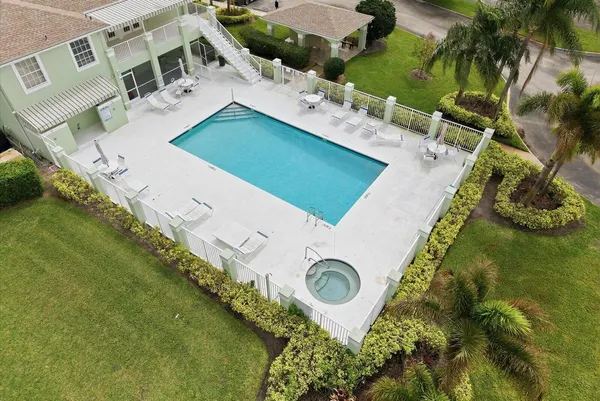 an aerial view of a house with garden space and lake view