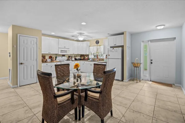 a kitchen with granite countertop a refrigerator and a stove top oven