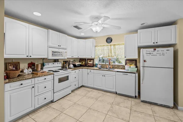 a kitchen with cabinets and stainless steel appliances