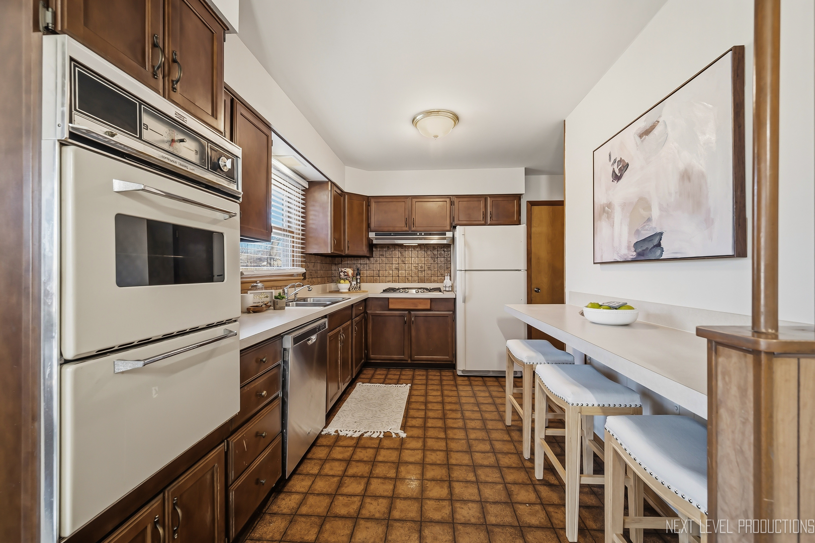 906 Carol Avenue Elgin, IL 60123 - Photo 16 of 31 a kitchen with stainless steel appliances a refrigerator sink and microwave