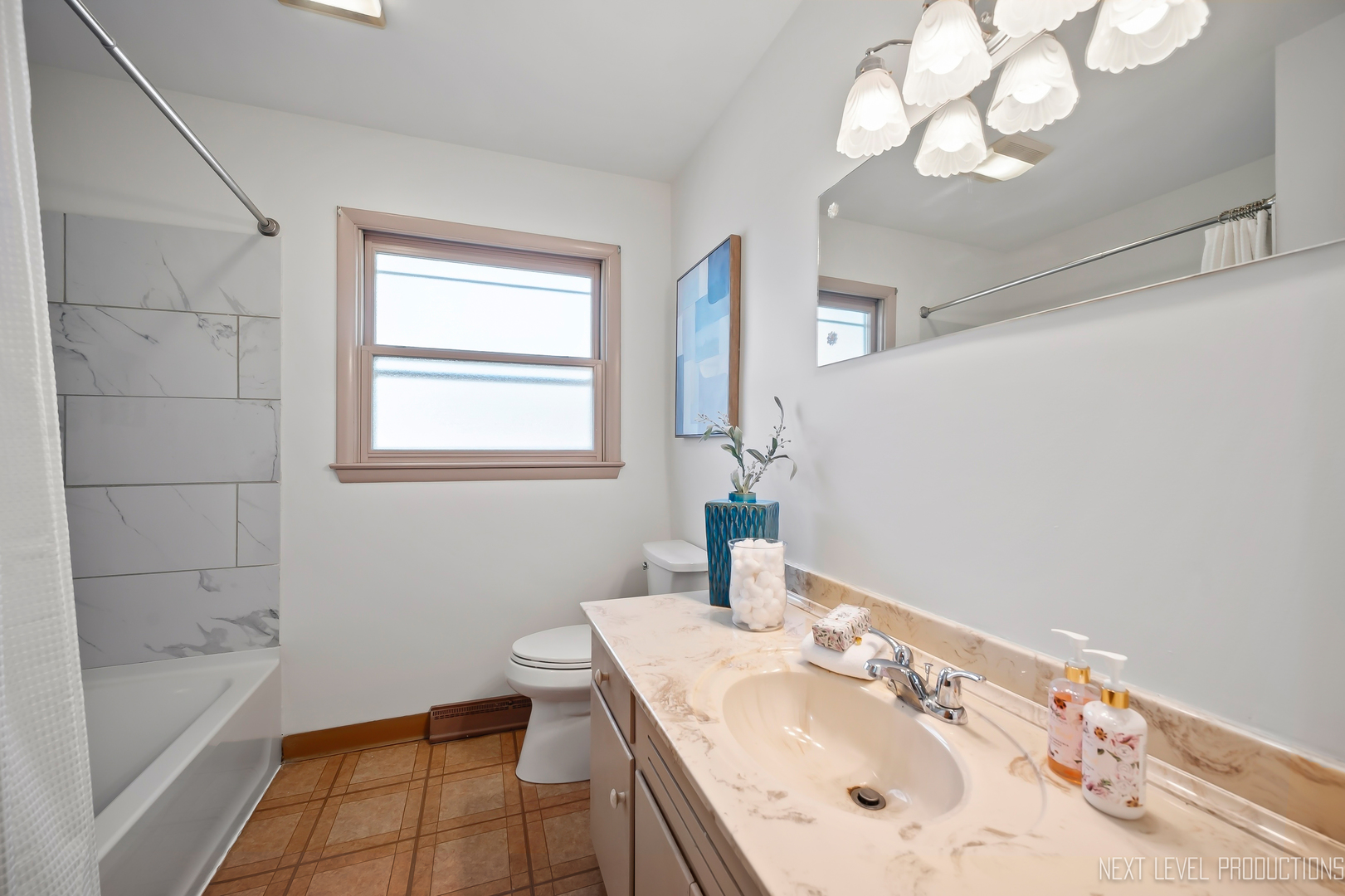906 Carol Avenue Elgin, IL 60123 - Photo 20 of 31 a bathroom with a sink a toilet and shower