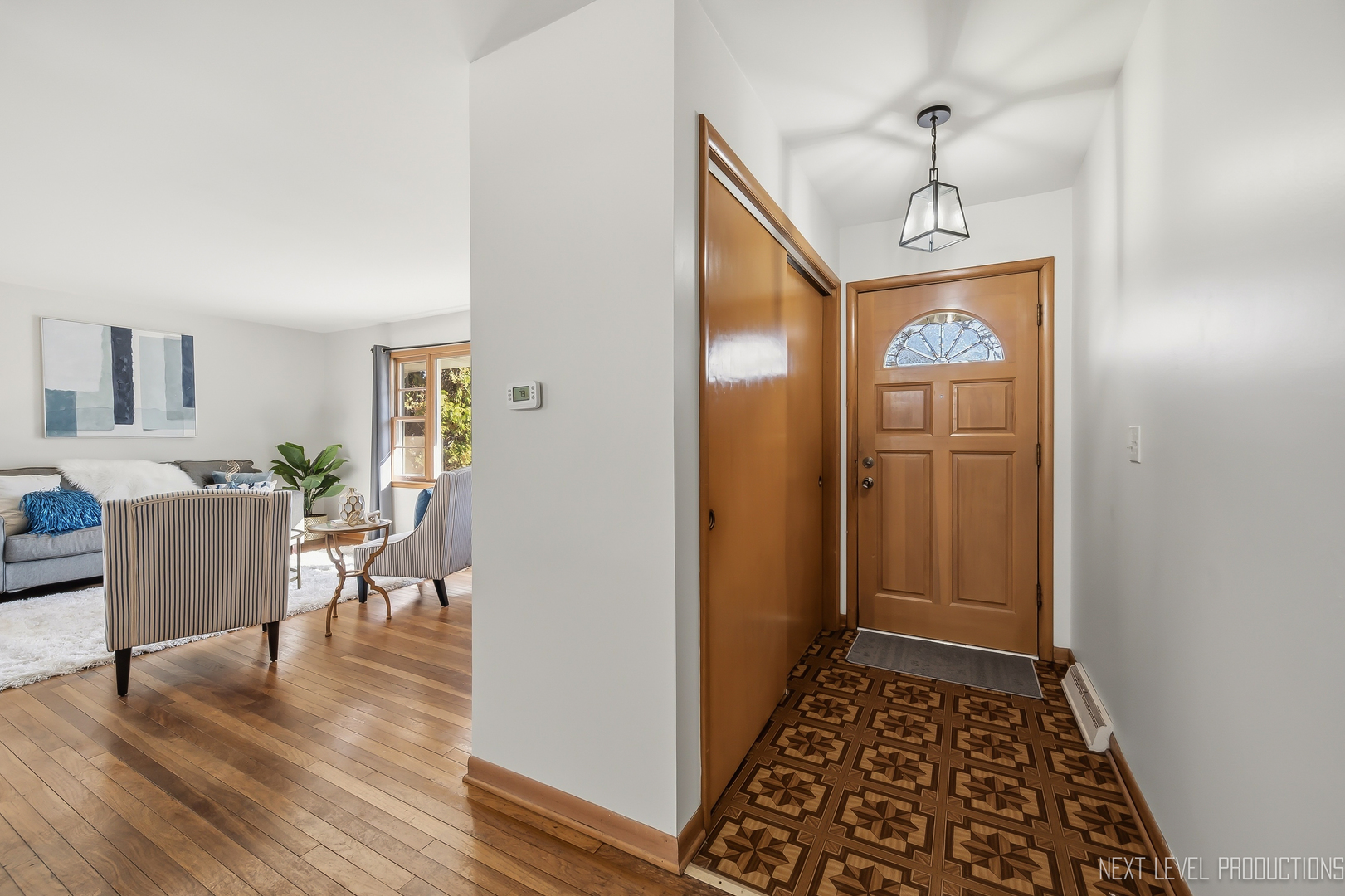 906 Carol Avenue Elgin, IL 60123 - Photo 7 of 31 a view of hallway with livingroom and wooden floor