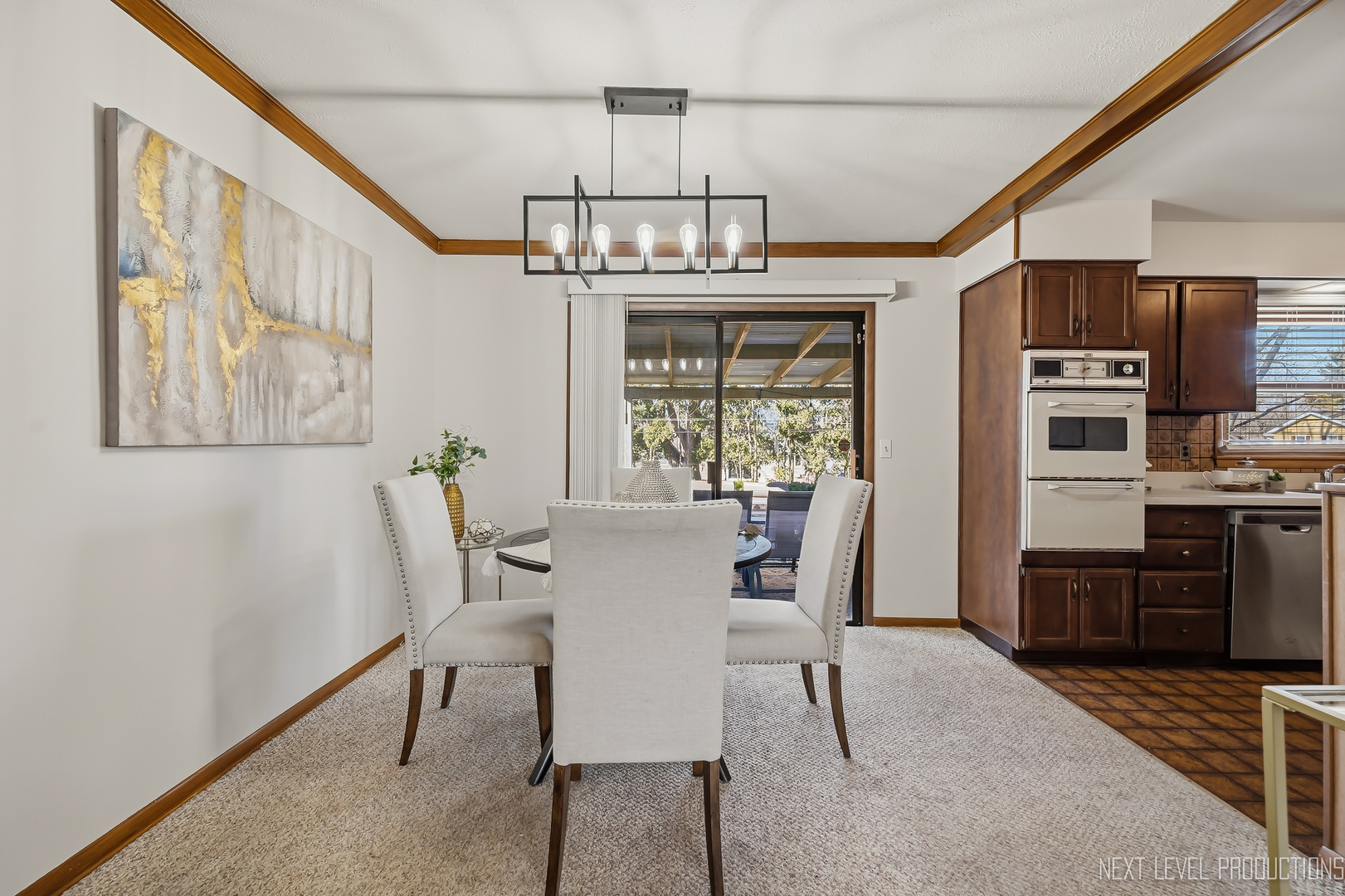 906 Carol Avenue Elgin, IL 60123 - Photo 8 of 31 a view of a dining room with furniture a chandelier and wooden floor