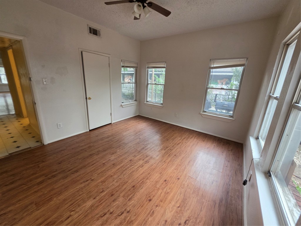 1226 West Gray Street, Unit 2 Houston, TX 77019 - Photo 11 of 14 a view of an empty room with wooden floor and a window