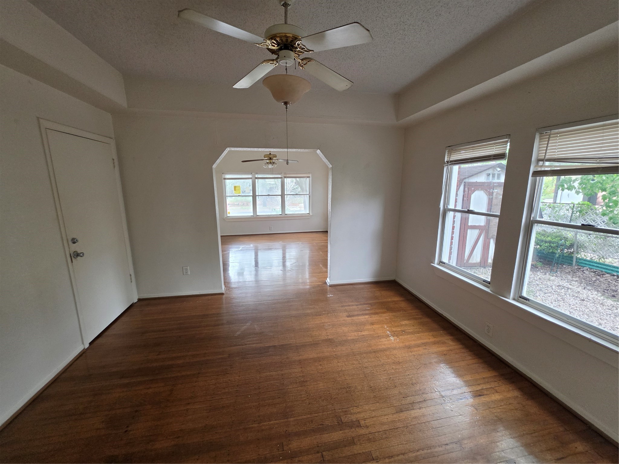 1226 West Gray Street, Unit 2 Houston, TX 77019 - Photo 3 of 14 wooden floor in an empty room with a window