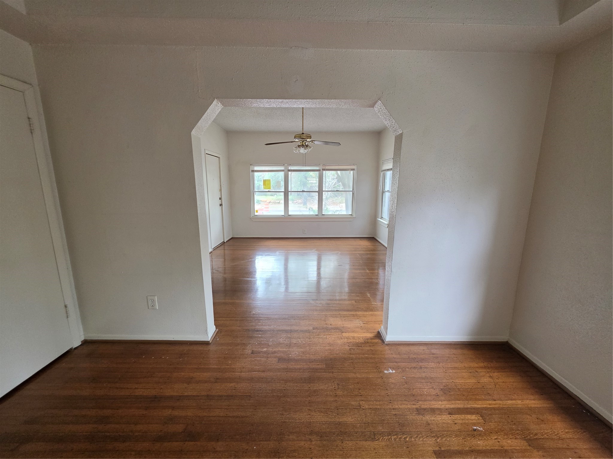 1226 West Gray Street, Unit 2 Houston, TX 77019 - Photo 5 of 14 an empty room with wooden floor and windows
