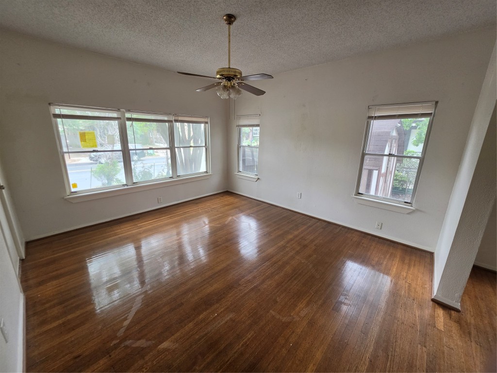 1226 West Gray Street, Unit 2 Houston, TX 77019 - Photo 6 of 14 a view of an empty room with wooden floor and a window