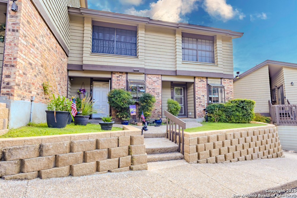 a view of a house with porch and chairs
