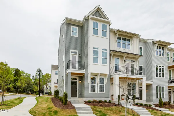 a front view of a building with a garden