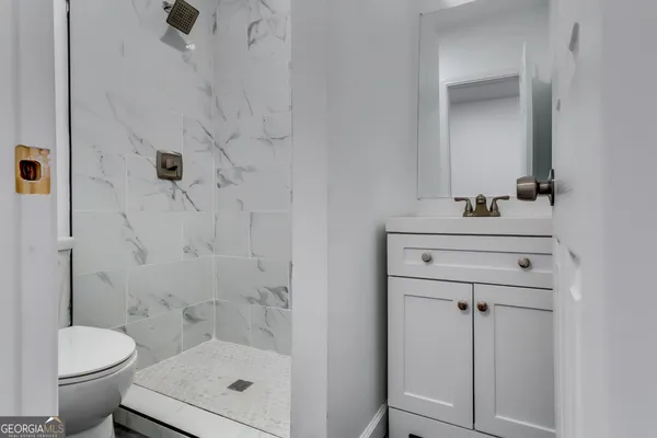 a bathroom with a sink toilet and shower