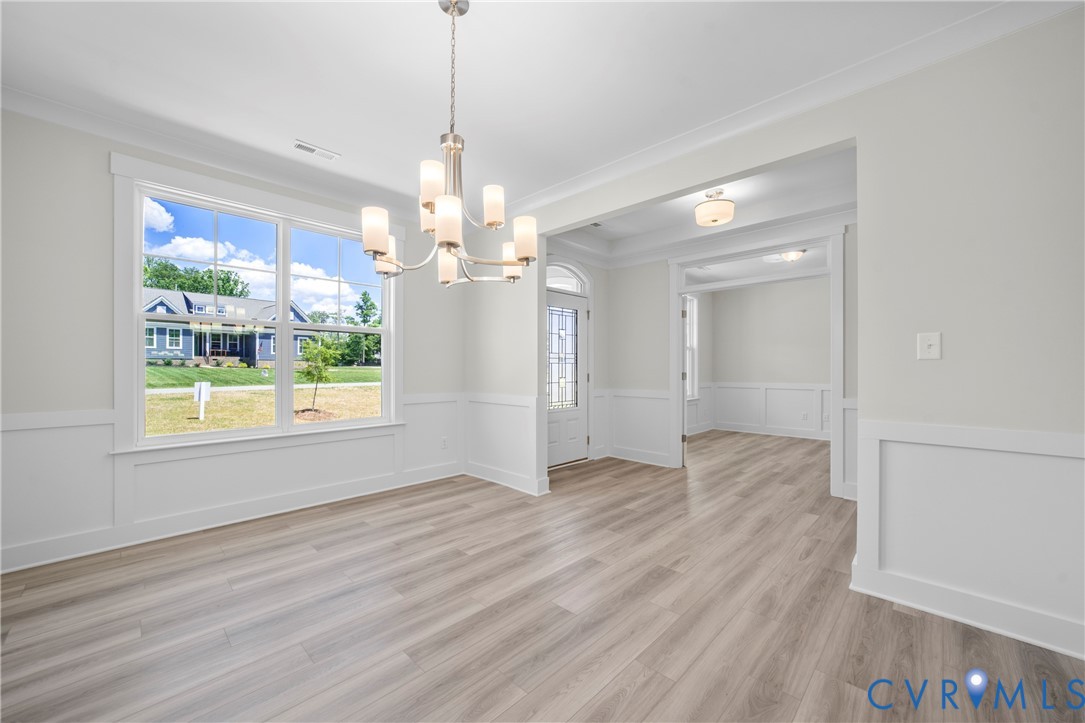 3917 Jett Court Gum Spring, VA 23065 - Photo 3 of 12 a view of a livingroom with a chandelier wooden floor and a chandelier