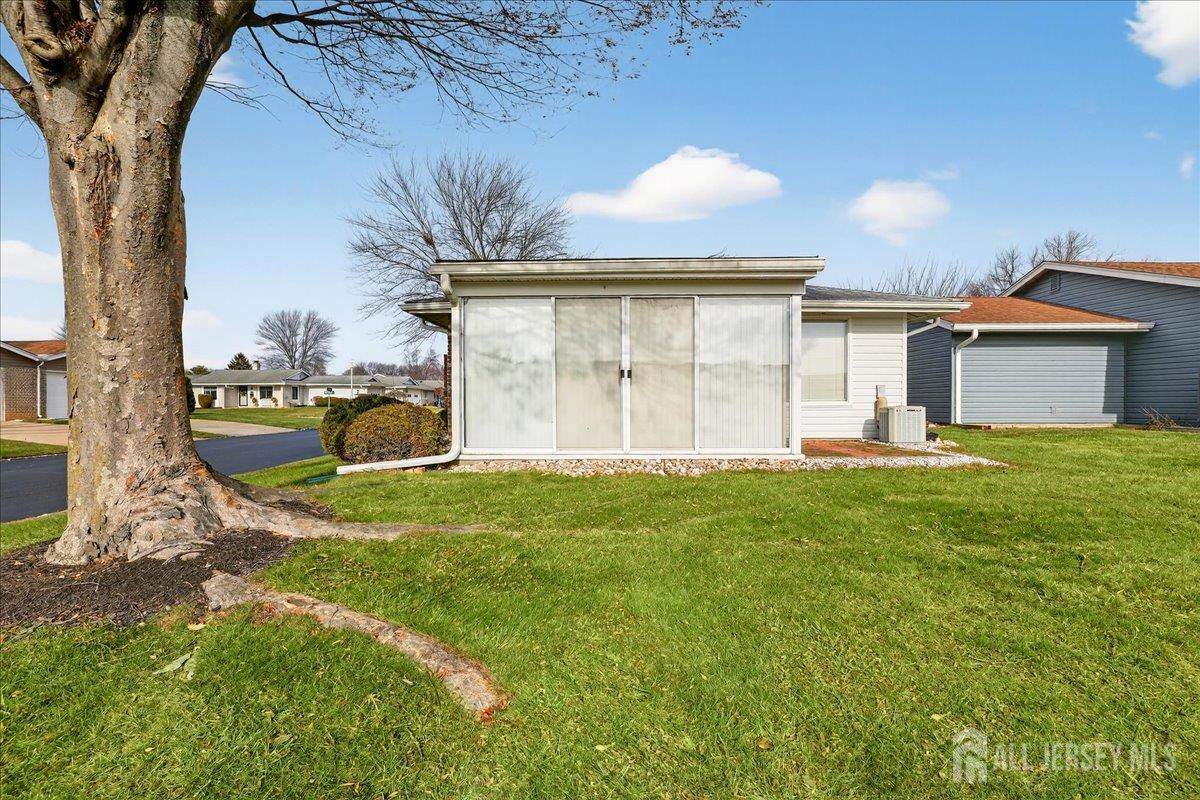 205A Newport Road, Unit A Monroe Township, NJ 08831 - Photo 18 of 26 a view of a porch in front of a house with a yard