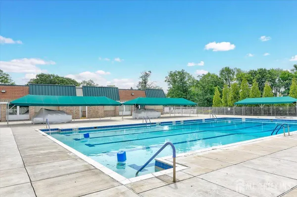 a view of swimming pool with a patio