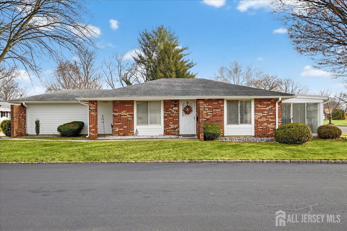 205A Newport Road, Unit A Monroe Township, NJ 08831 - Photo 2 of 26 a front view of a house with a yard and garage