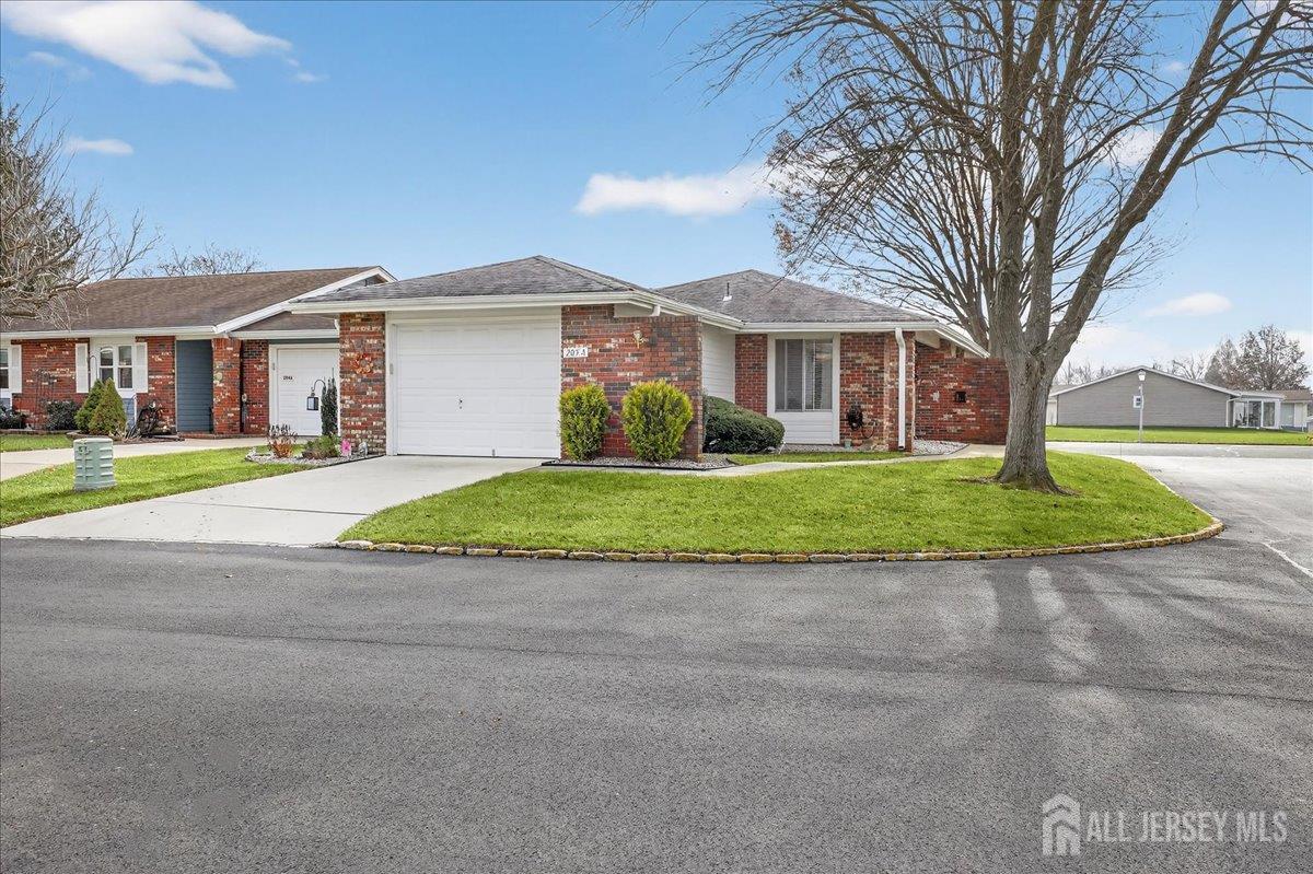 205A Newport Road, Unit A Monroe Township, NJ 08831 - Photo 3 of 26 a view of a house with a big yard and large trees
