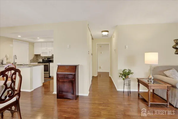 a living room with furniture and kitchen view