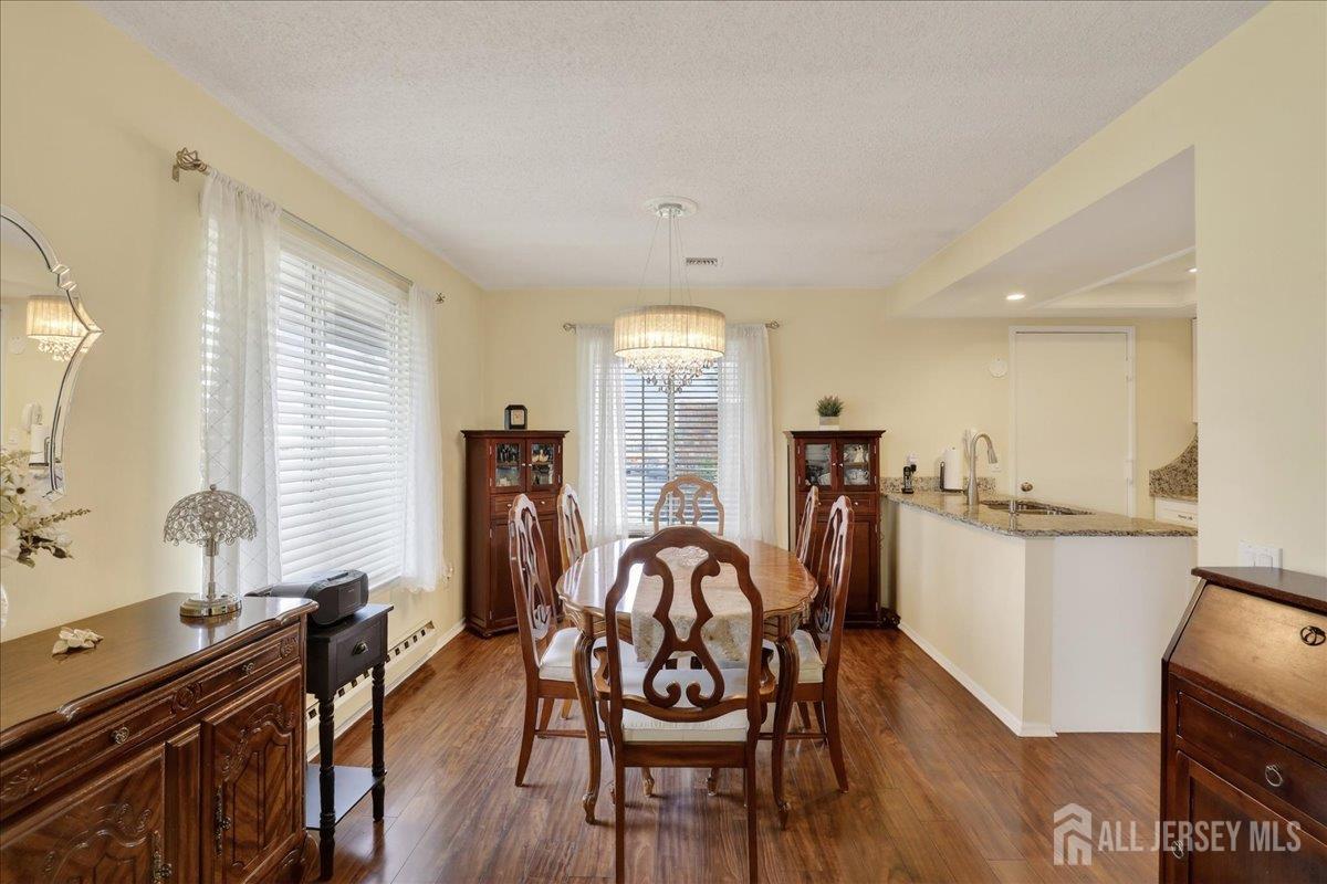 205A Newport Road, Unit A Monroe Township, NJ 08831 - Photo 8 of 26 a view of a dining room with furniture and wooden floor