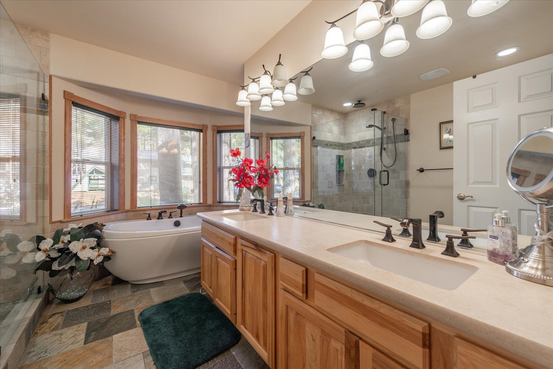 955 The Drive Tahoe City, CA 96145 - Photo 12 of 21 a spacious bathroom with a sink large mirror and a bathtub