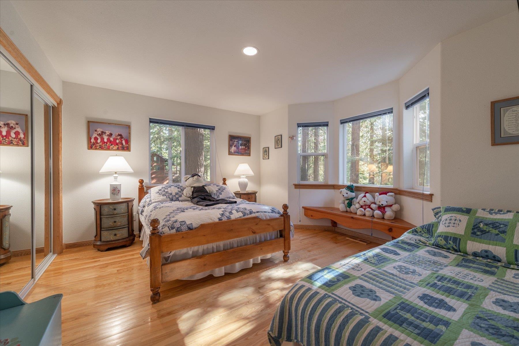 955 The Drive Tahoe City, CA 96145 - Photo 15 of 21 a spacious bedroom with two beds and a couch