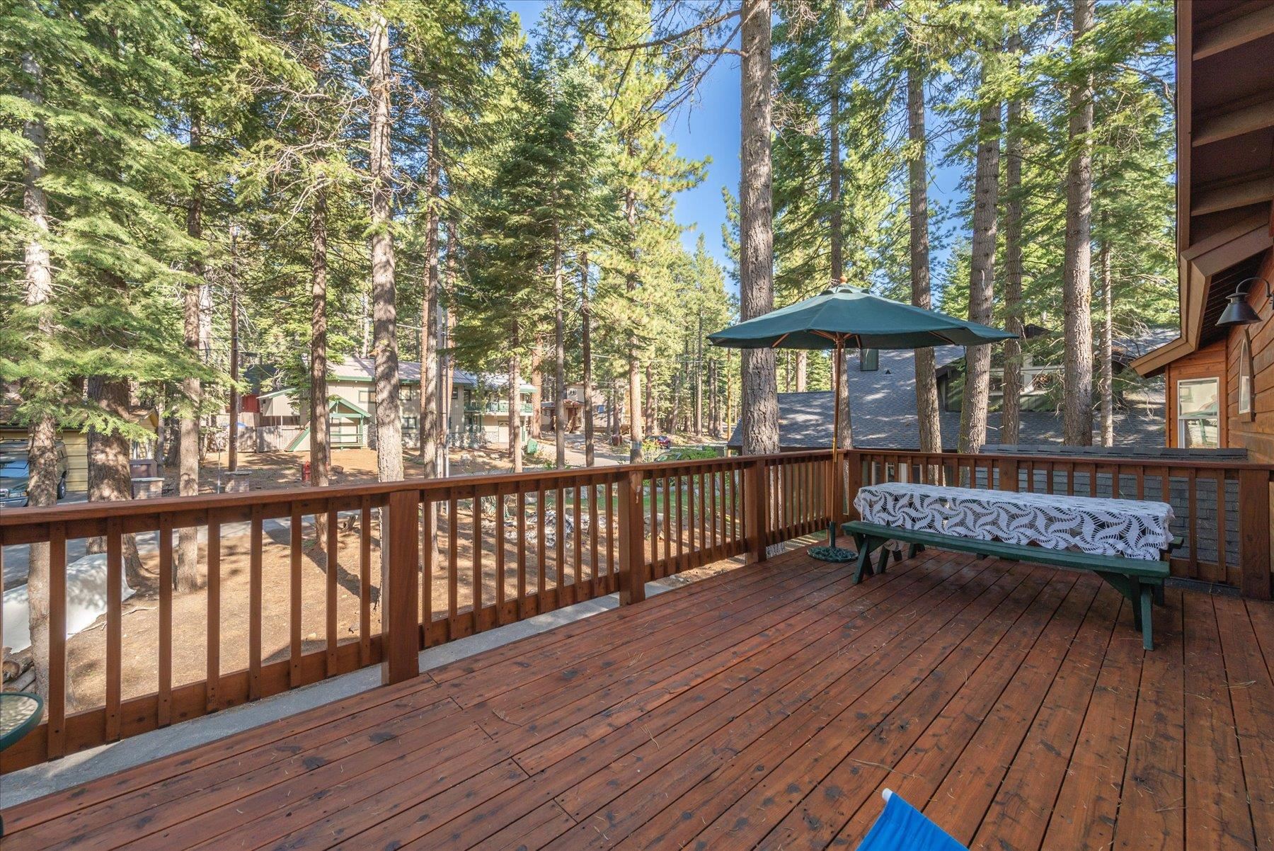 955 The Drive Tahoe City, CA 96145 - Photo 19 of 21 a view of a wooden deck with a bench and trees
