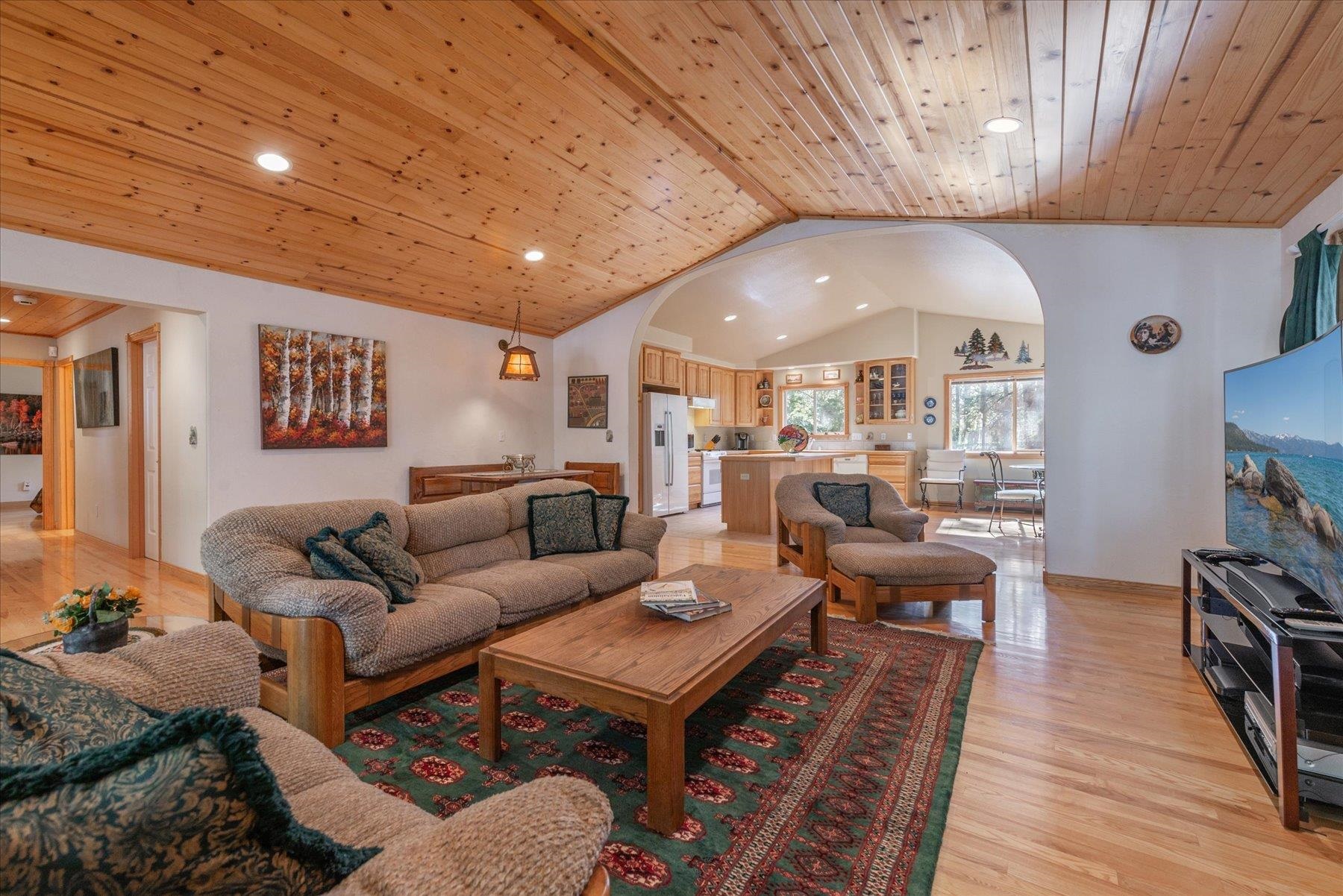 955 The Drive Tahoe City, CA 96145 - Photo 6 of 21 a living room with furniture a wooden floor and a bookshelf