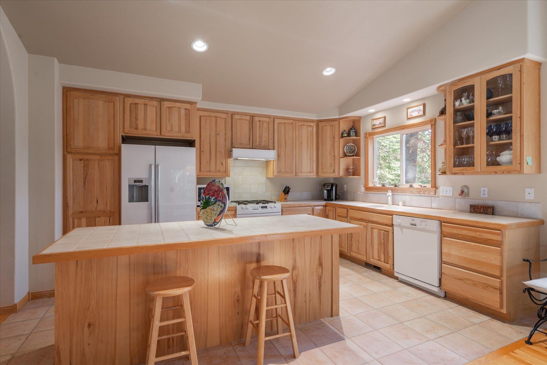 955 The Drive Tahoe City, CA 96145 - Photo 9 of 21 a kitchen with stainless steel appliances granite countertop a stove a sink dishwasher and a refrigerator