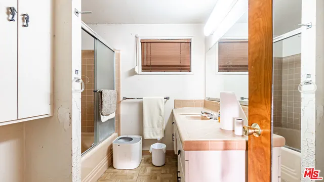 a bedroom with a bed a table and chairs